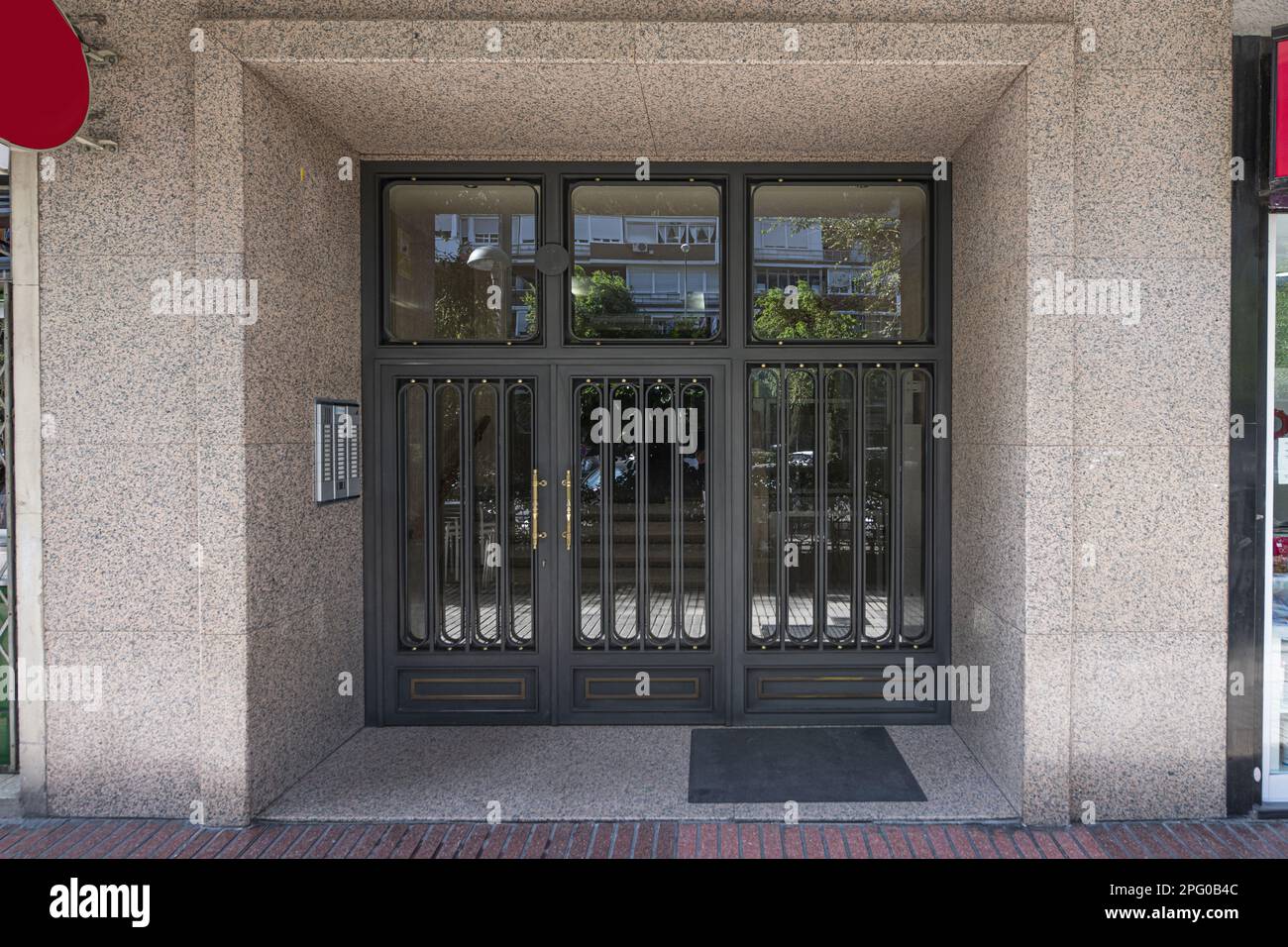 Access portal to a residential housing building with a black metal door