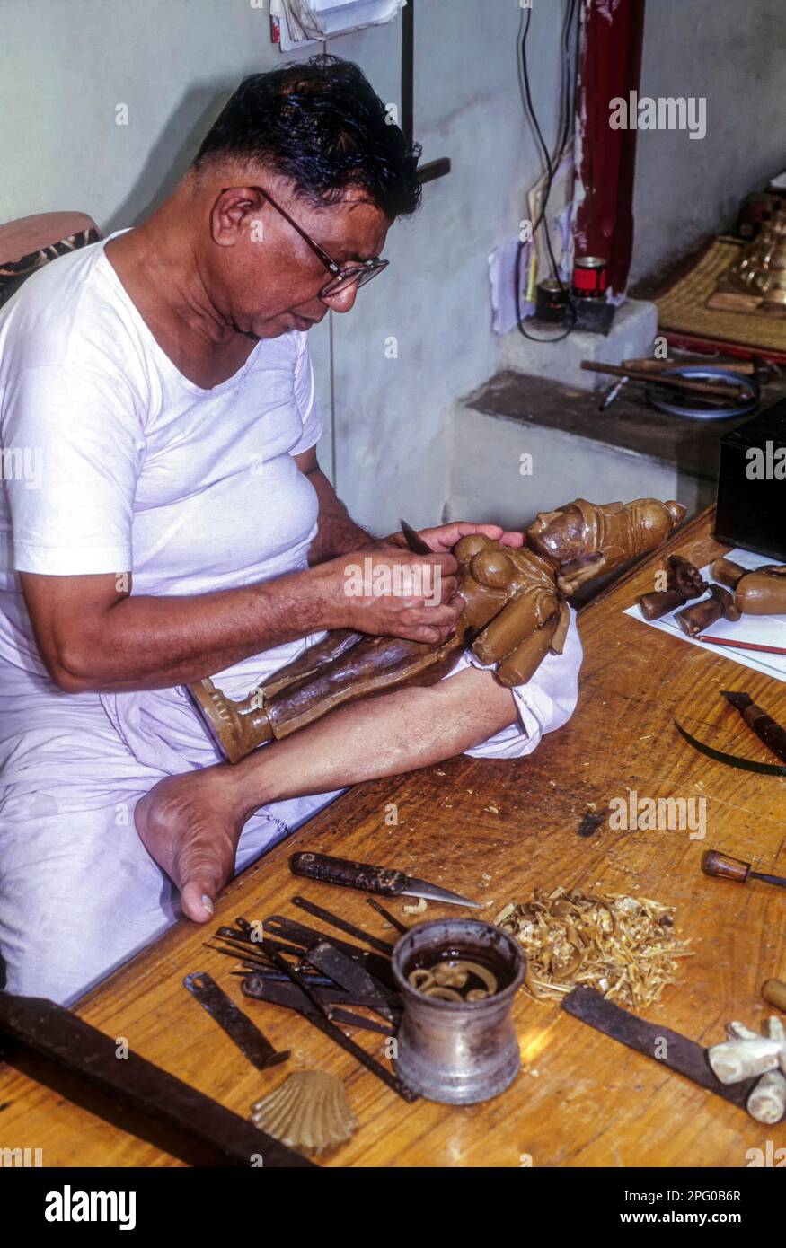 An artisan making wax mould for a bronze sculpture in Swamimalai, Tamil