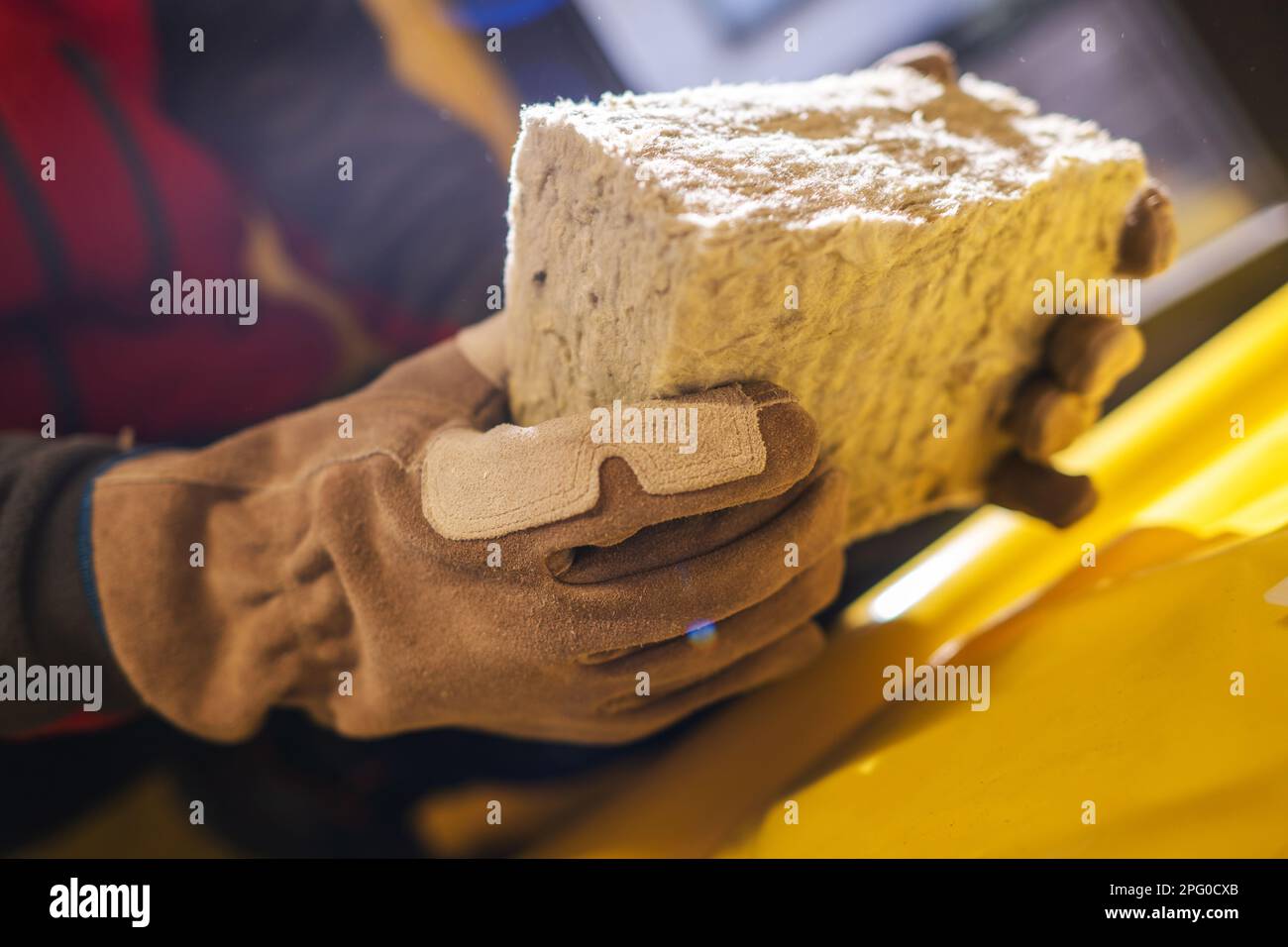 Small Piece of Mineral Wool Insulation Material in Hands of Insulating