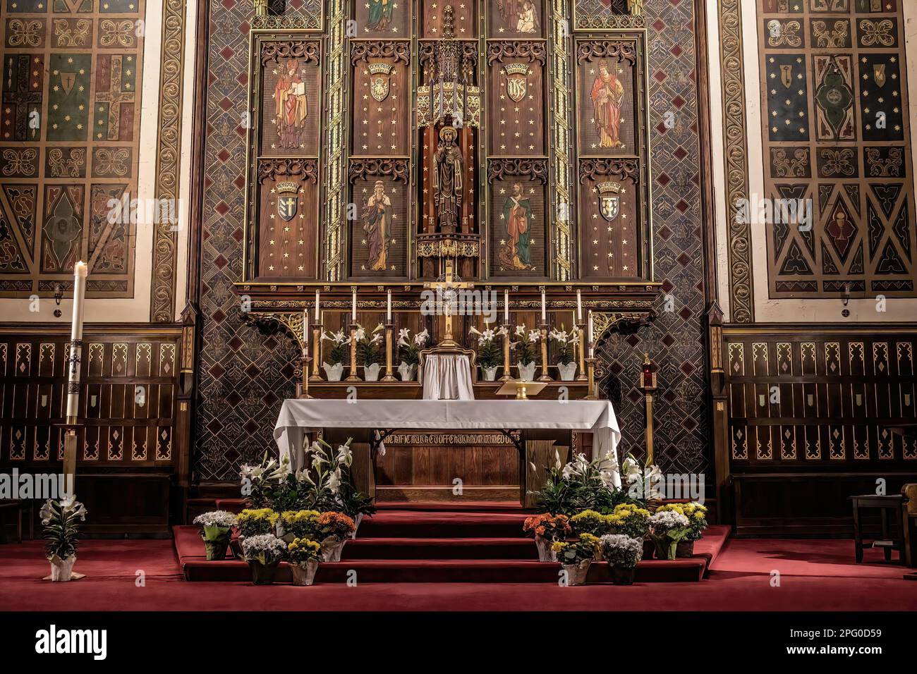 St. Mark's Catholic Church with Easter flowers around the altar; Jesus Christ of the Universe central figure, St. Paul, Minnesota USA. Stock Photo