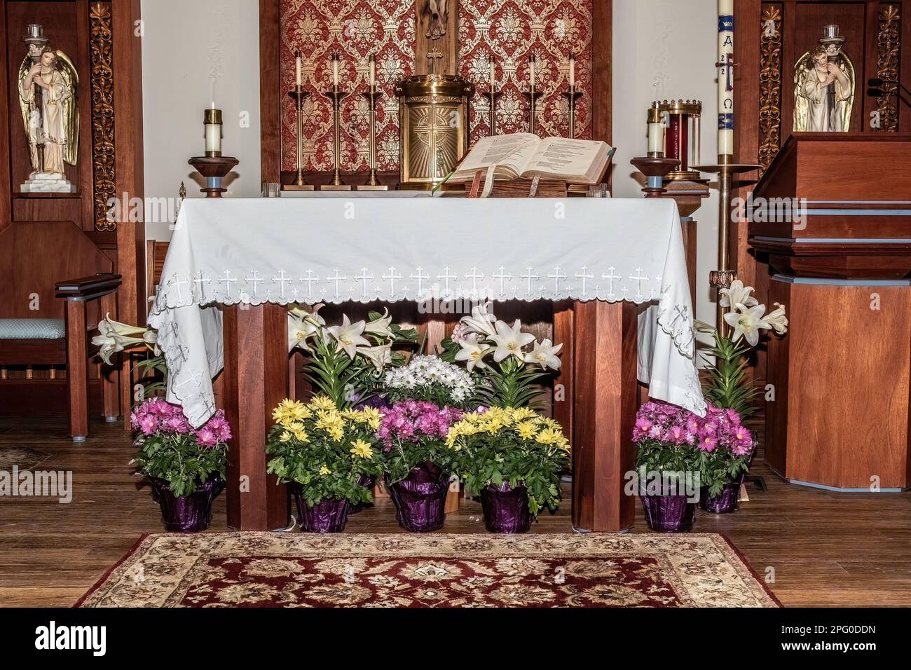 Easter flowers around the altar at St. Joseph's Catholic Church in Taylors Falls, Minnesota USA. Stock Photo