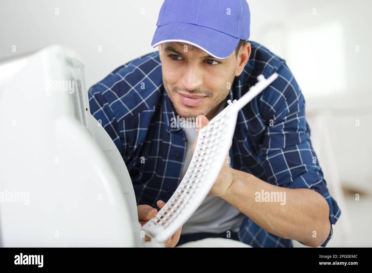 installation service by technican worker checking the air filter Stock Photo