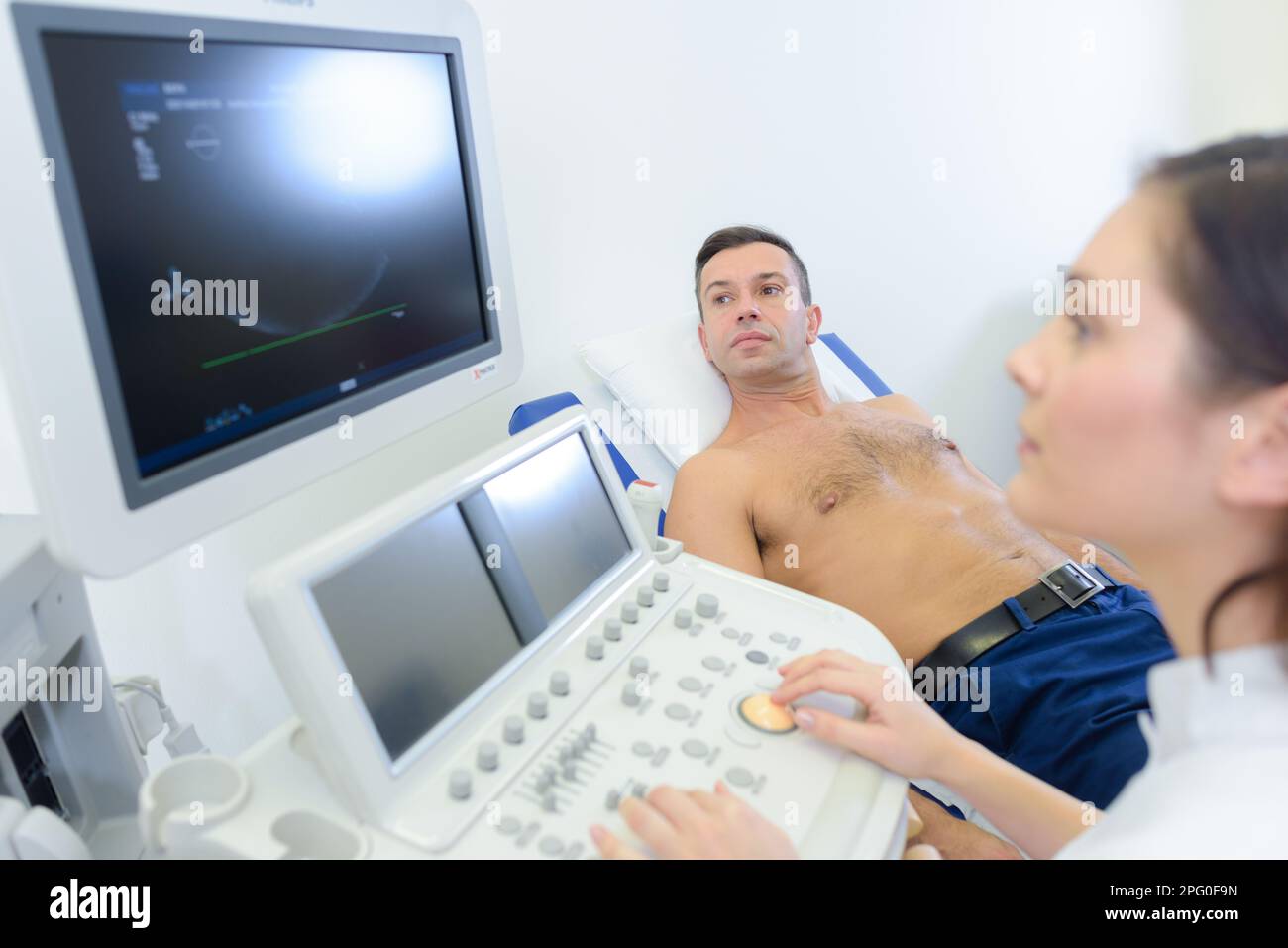Male patient undergoing ultrasound of thyroid gland stock photo alamy