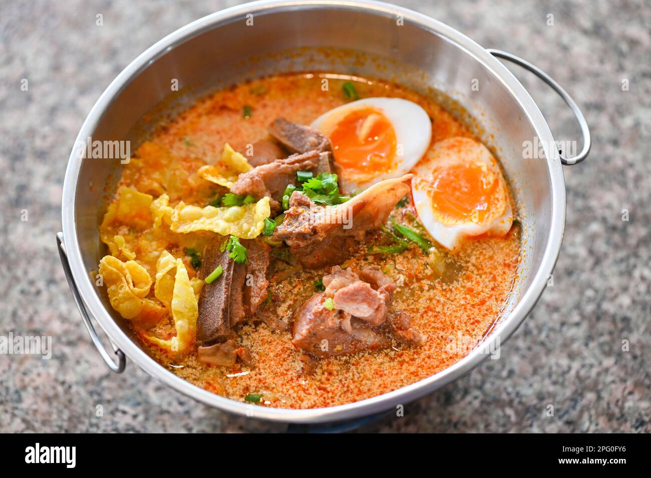 curry bone soup pork bone soup with boiled eggs in hot pot, Thai food