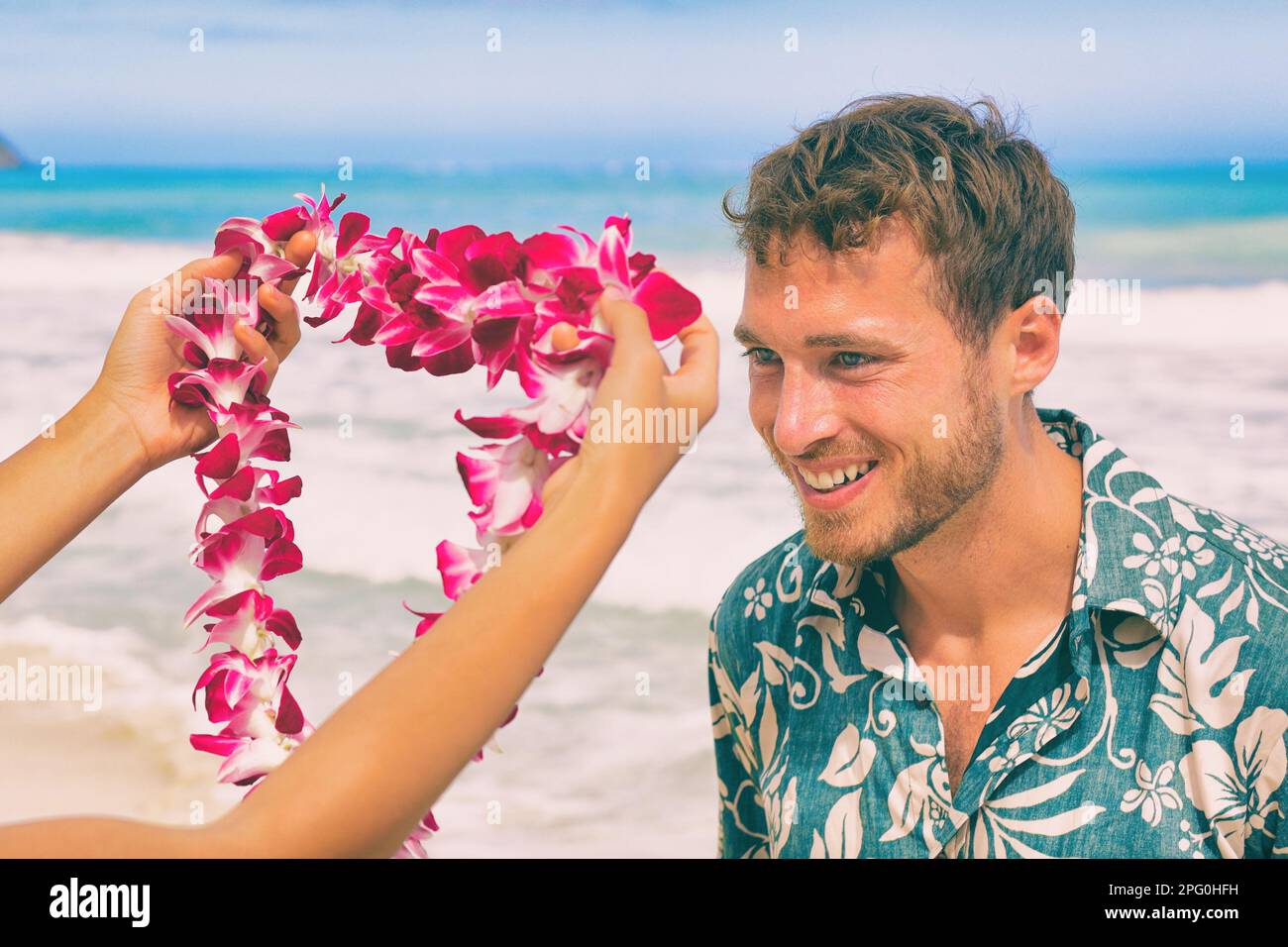 Hawaii welcome hawaiian lei flower necklace offering to tourist as welcoming gesture for luau party or beach vacation. Polynesian tradition. Stock Photo