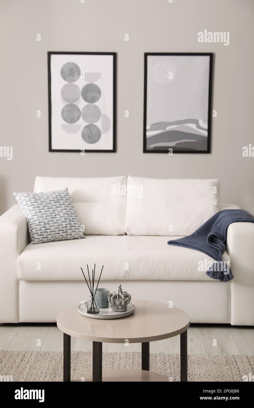 Stylish living room interior with white sofa and small coffee table ...