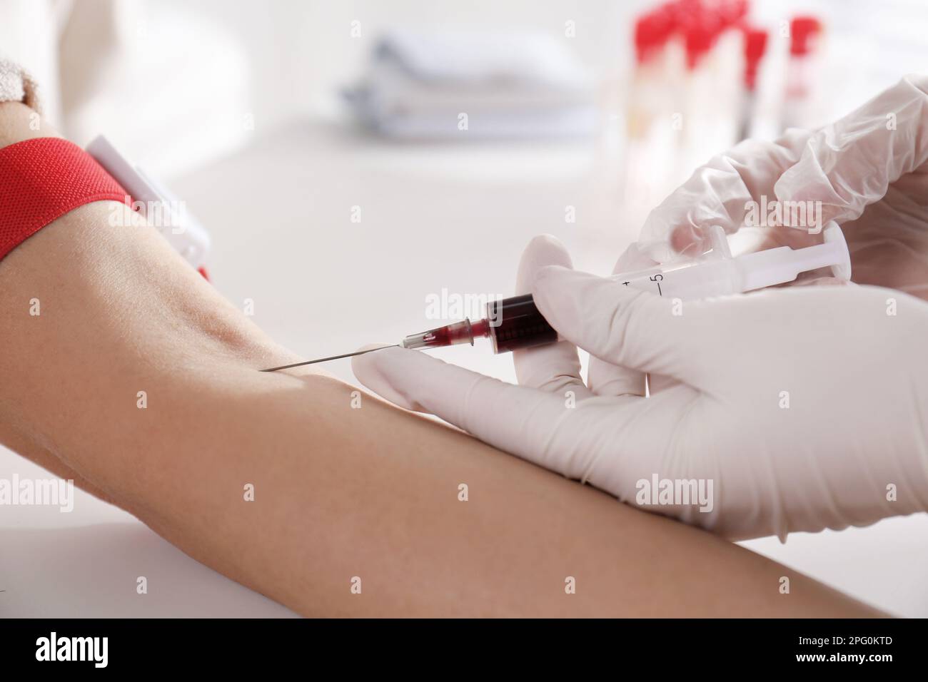 Nurse drawing blood sample from patient in clinic, closeup Stock Photo