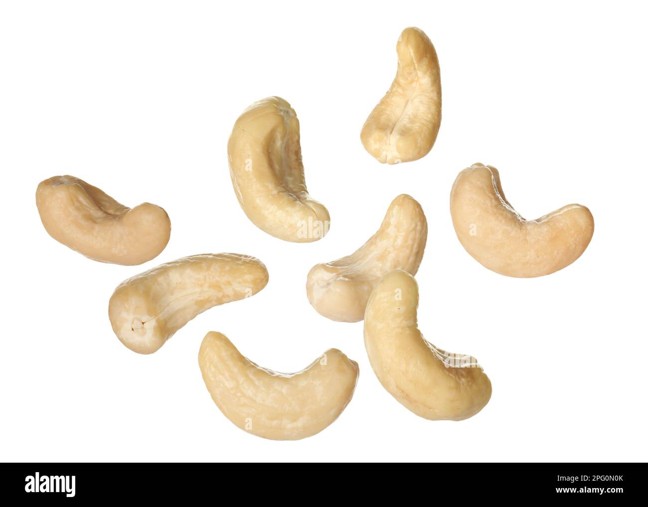Tasty raw cashew nuts falling on white background Stock Photo