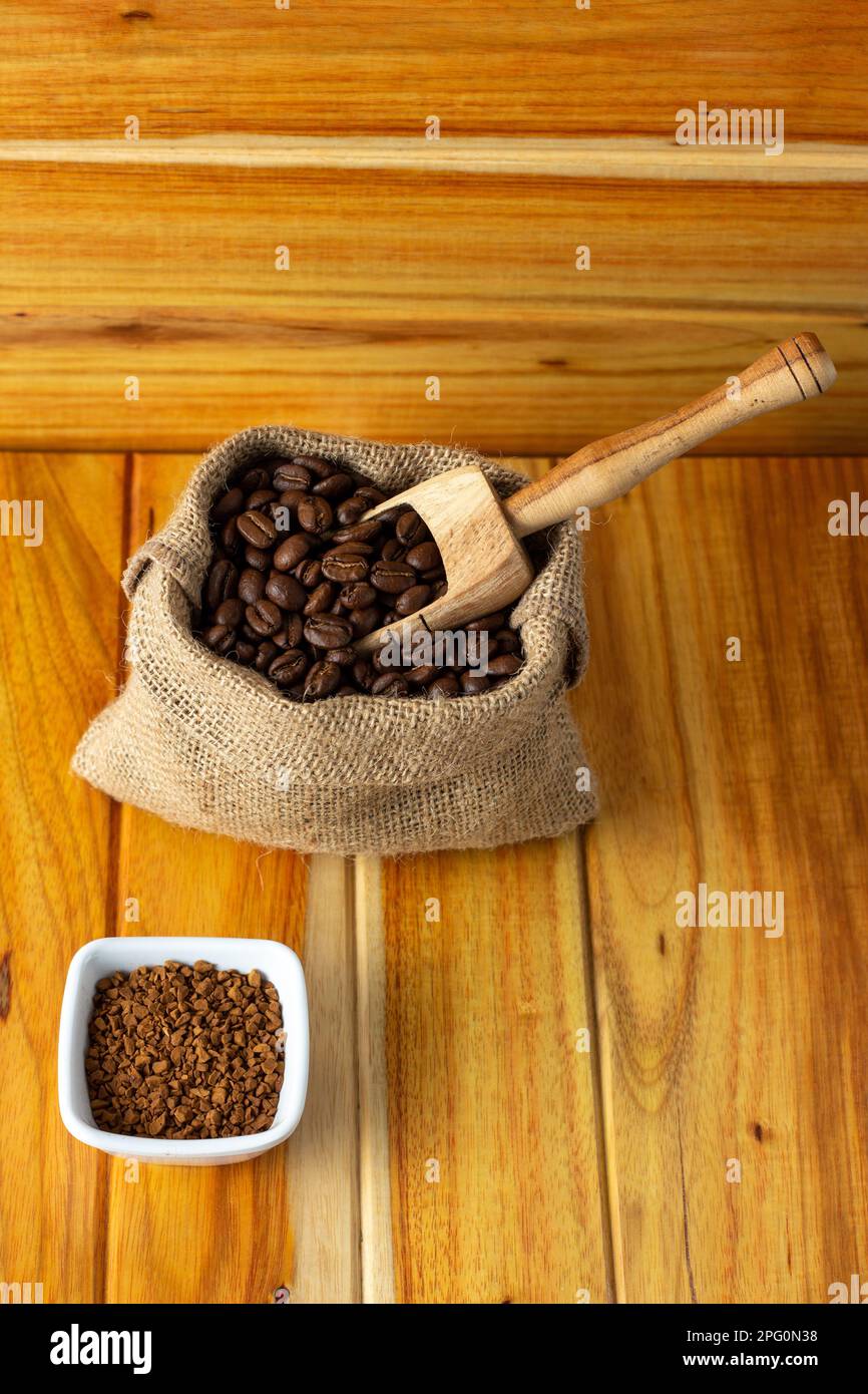 fresh coffee beans in cloth sacks - sack with coffee beans and wooden spoon Stock Photo