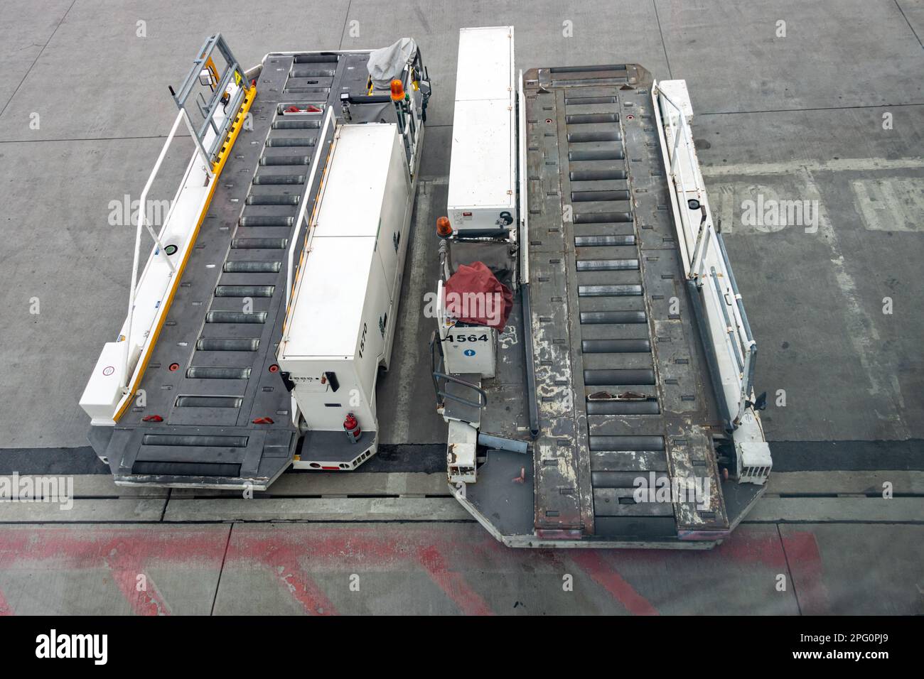 A two mobile cargo transporter parked at an international airport Stock Photo
