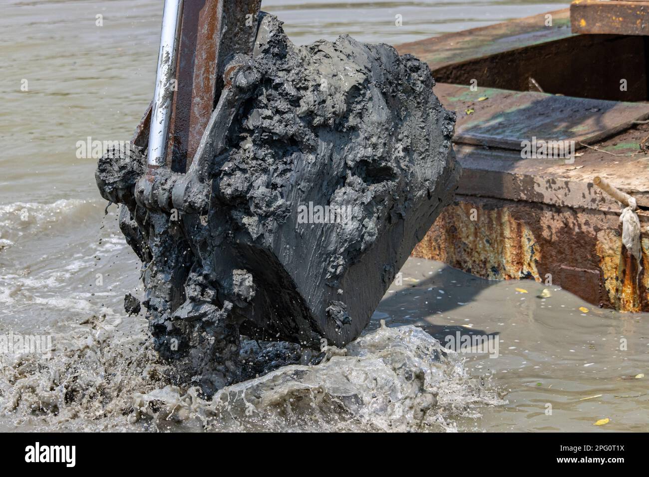 Dredging the bottom of water area, view of the bucket of the floating