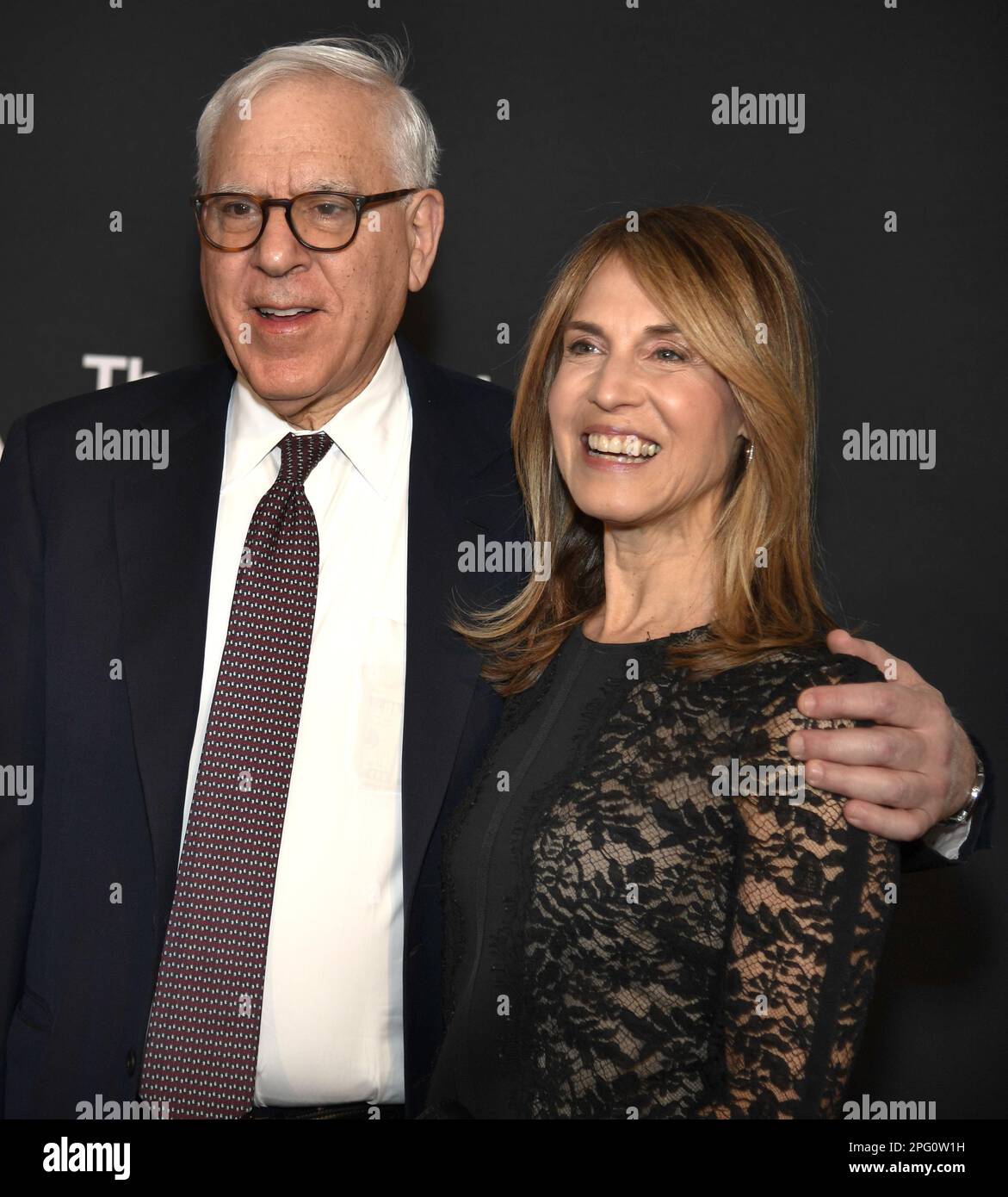 Washington, United States. 19th Mar, 2023. Kennedy Center Chairman of the Board, and Co-Chair of The Carlyle Group, David M. Rubenstein and date Caryn Zucker pose for photographers as they arrive on the red carpet for the 2023 Kennedy Center Mark Twain Prize for American Humor gala evening, honoring comedian Adam Sandler, in Washington, DC on Sunday, March 19, 2023. Photo by Mike Theiler/UPI Credit: UPI/Alamy Live News Stock Photo