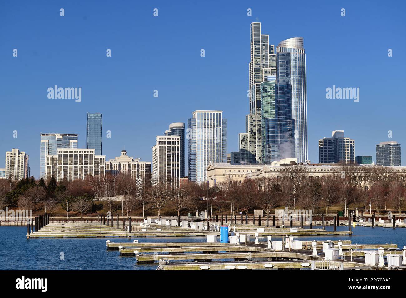Chicago, Illinois, USA. Turned over boats in an empty harbor provide a foreground for buildings including NEMA Chicago and One Museum Park. Stock Photo