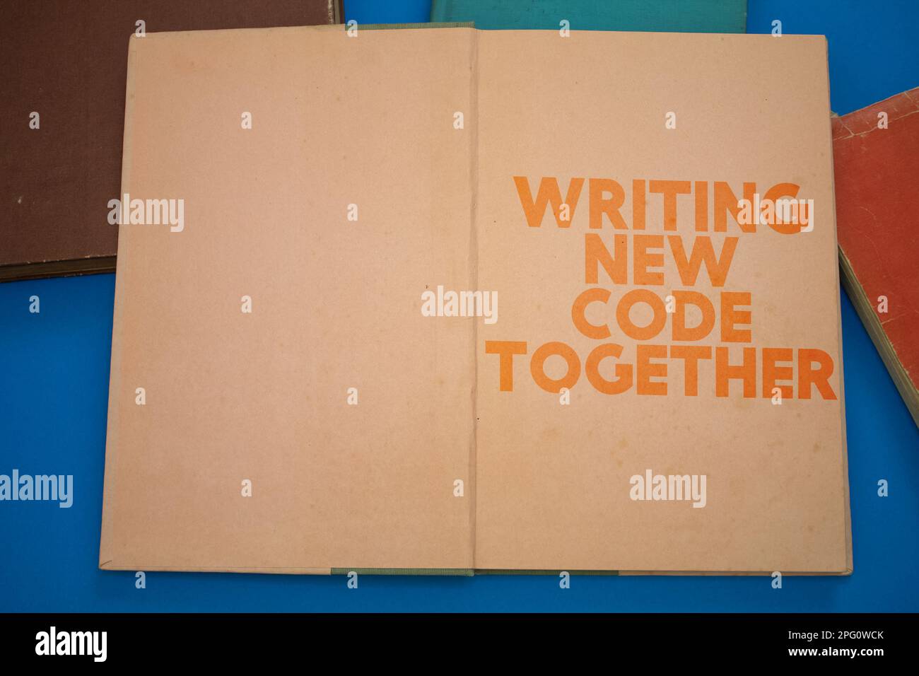 Writing New Code Together word in opened book with vintage, natural