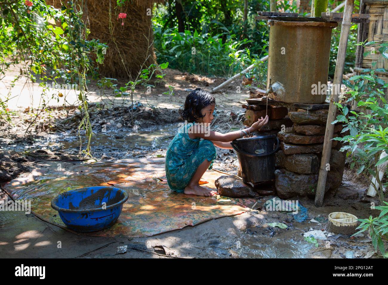'Simple joys in the village: A little girl plays in tubewell water.' Photo Credit: Ripon Abraham Tolentino Stock Photo
