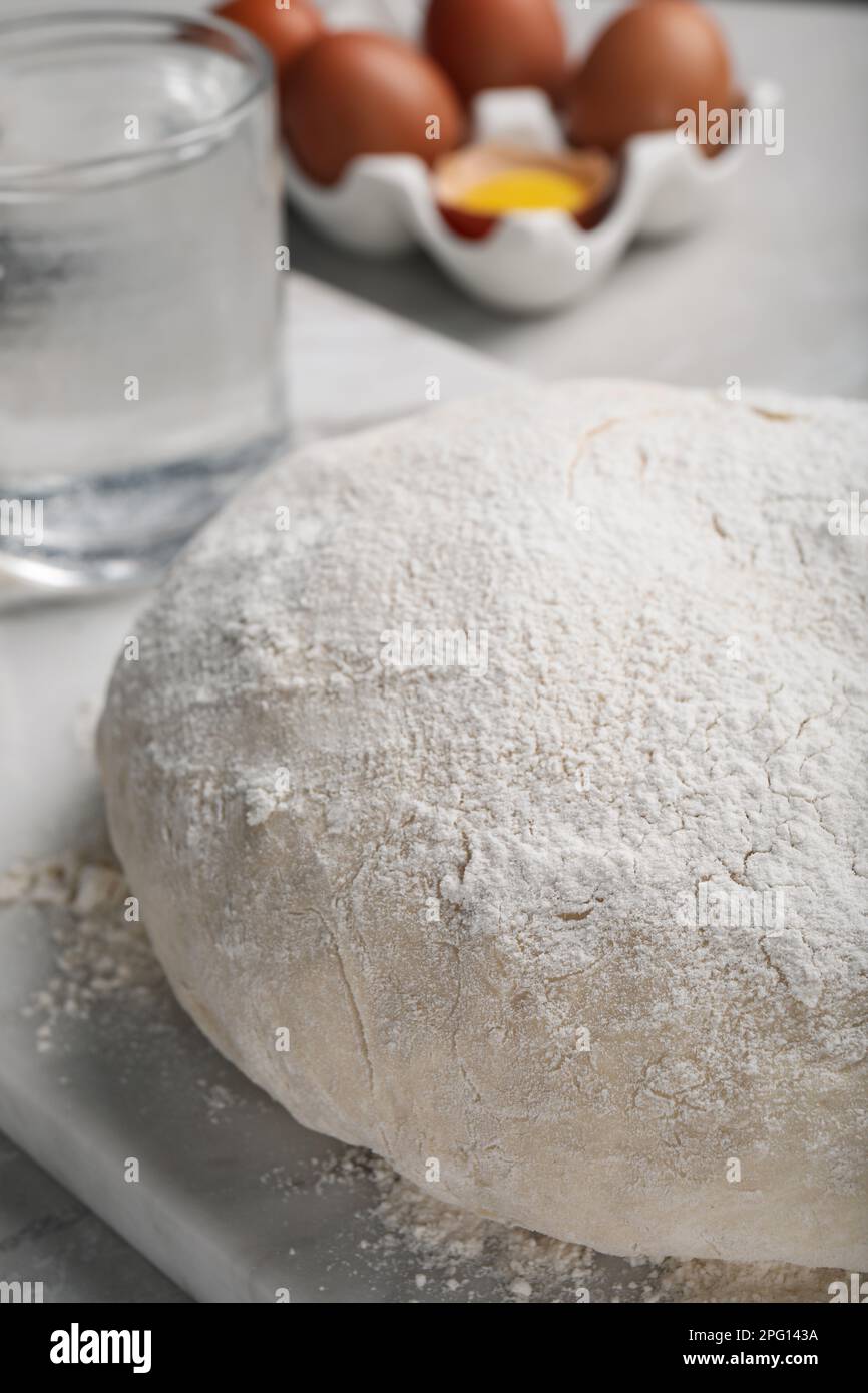 Dough on white marble board, closeup. Sodawater bread recipe Stock