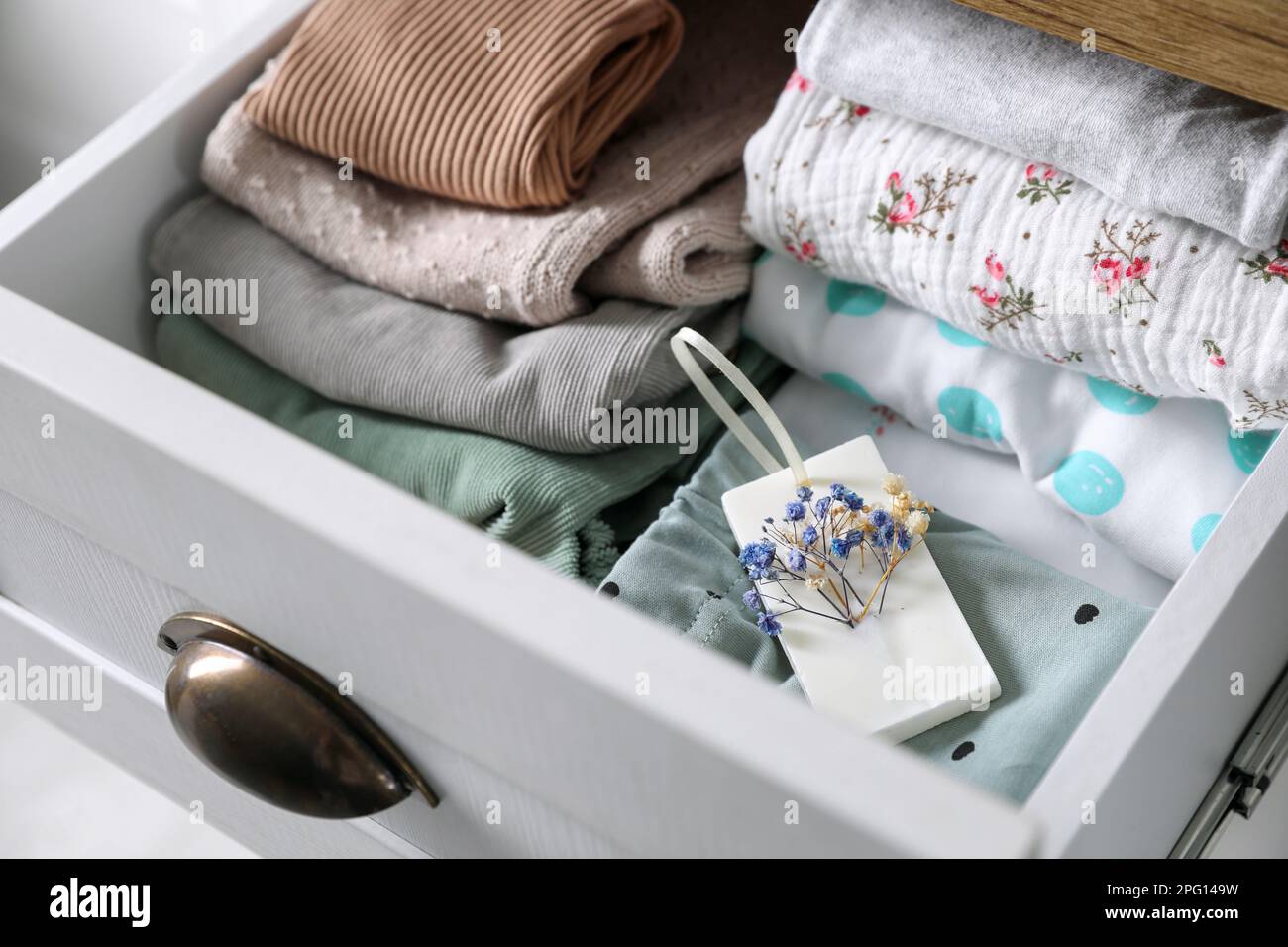 Beautiful scented wax sachet and clothes in dresser drawer, closeup Stock  Photo - Alamy