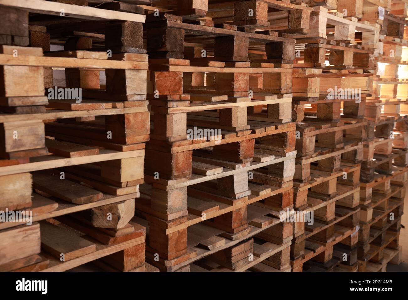 Many empty wooden pallets stacked in warehouse Stock Photo Alamy