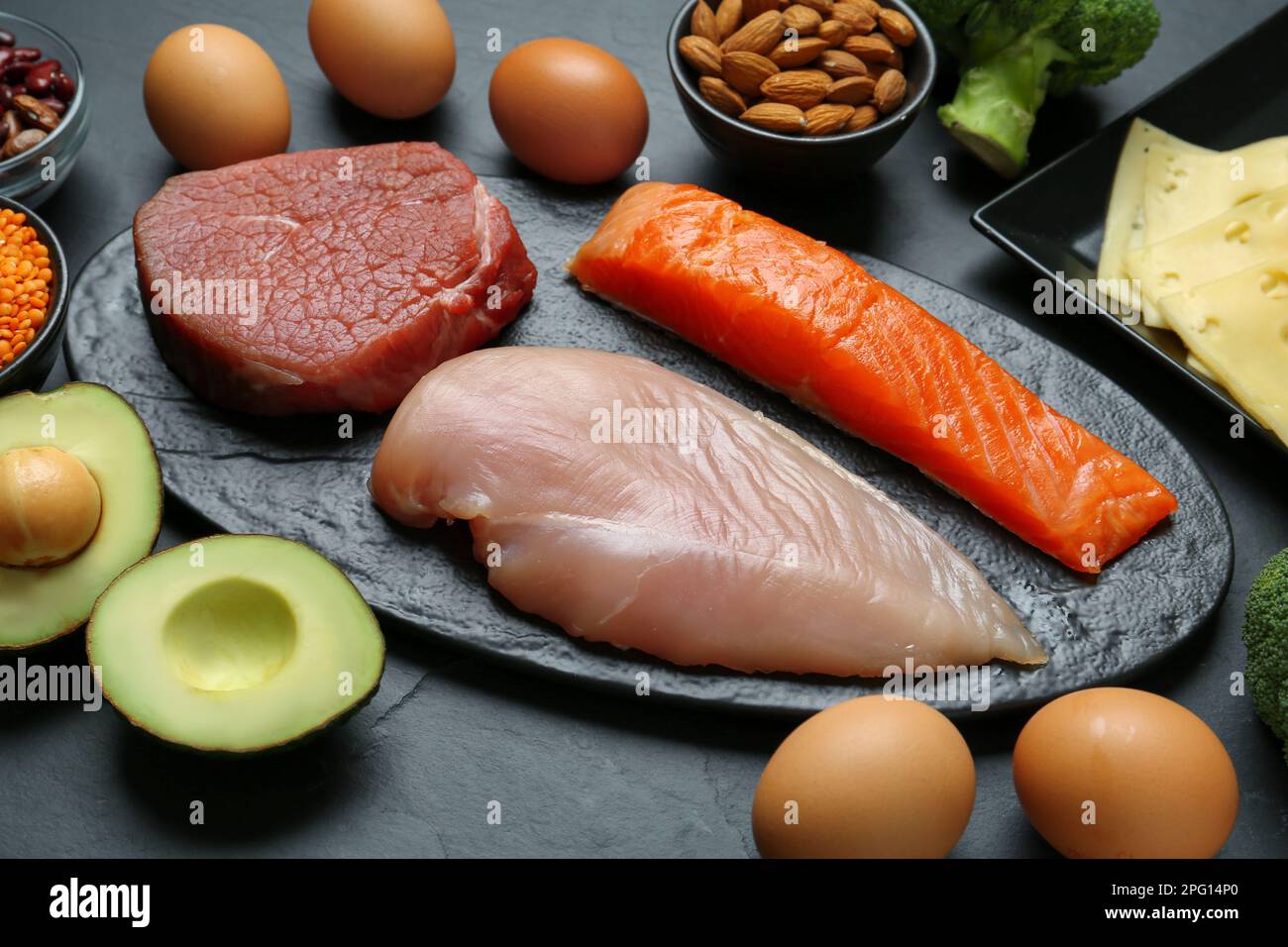 Fresh meat and other products on black table. Sources of essential