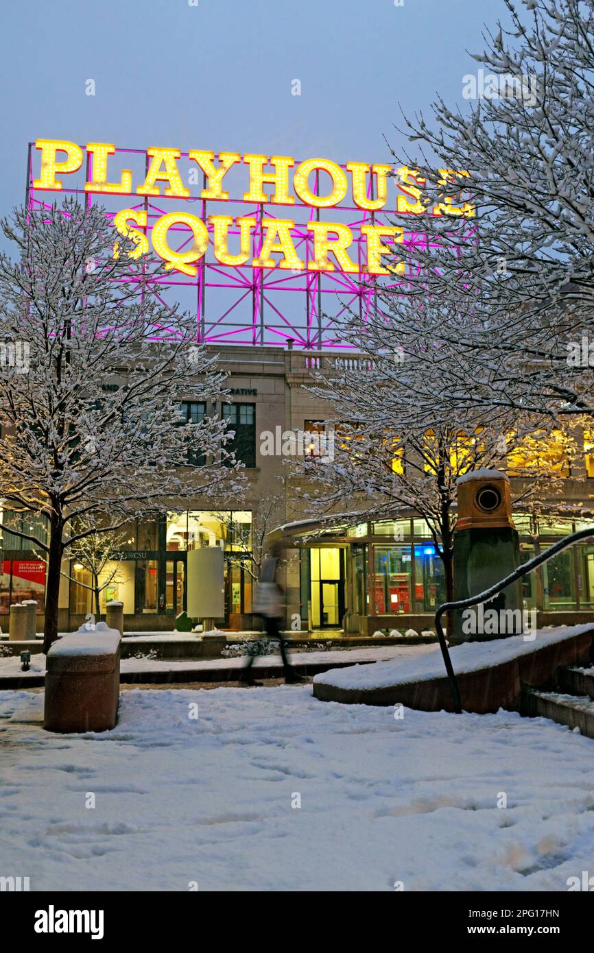 Playhouse Square retro stick-sign is illuminated at dusk while fresh snow covers the ground and trees on January 22, 2023. Stock Photo