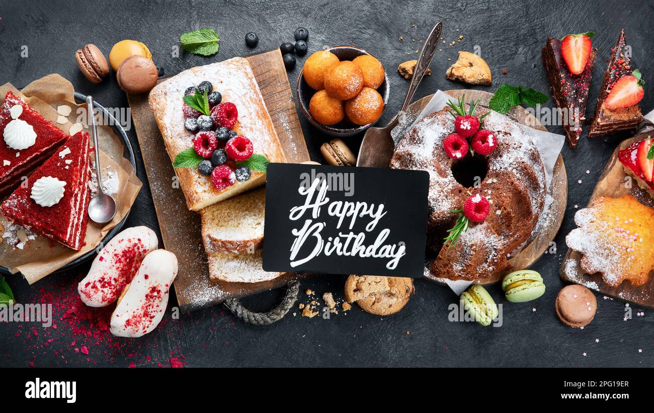 Different desserts on dark background. Delicious sweet dessert table with pound cake, chocolate and red velvet cakes. Holiday  sweet eating concept. T Stock Photo