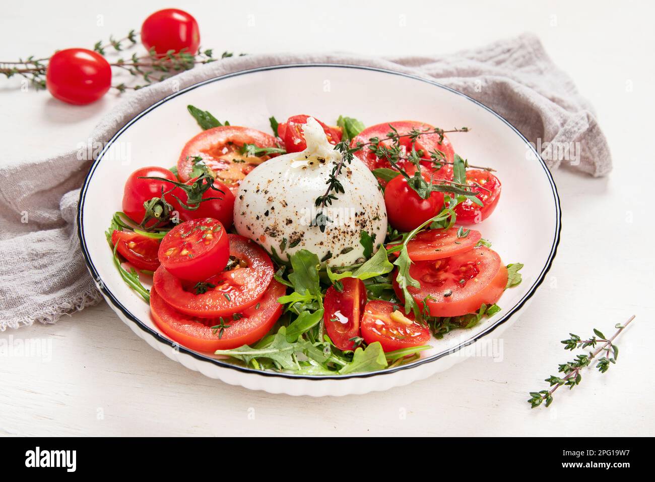 Tomato, basil, mozzarella. Caprese salad with olive oil. Top view, white background. Stock Photo