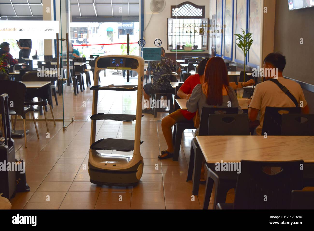 Robot waiter is serving food in cafe in Penang. Stock Photo