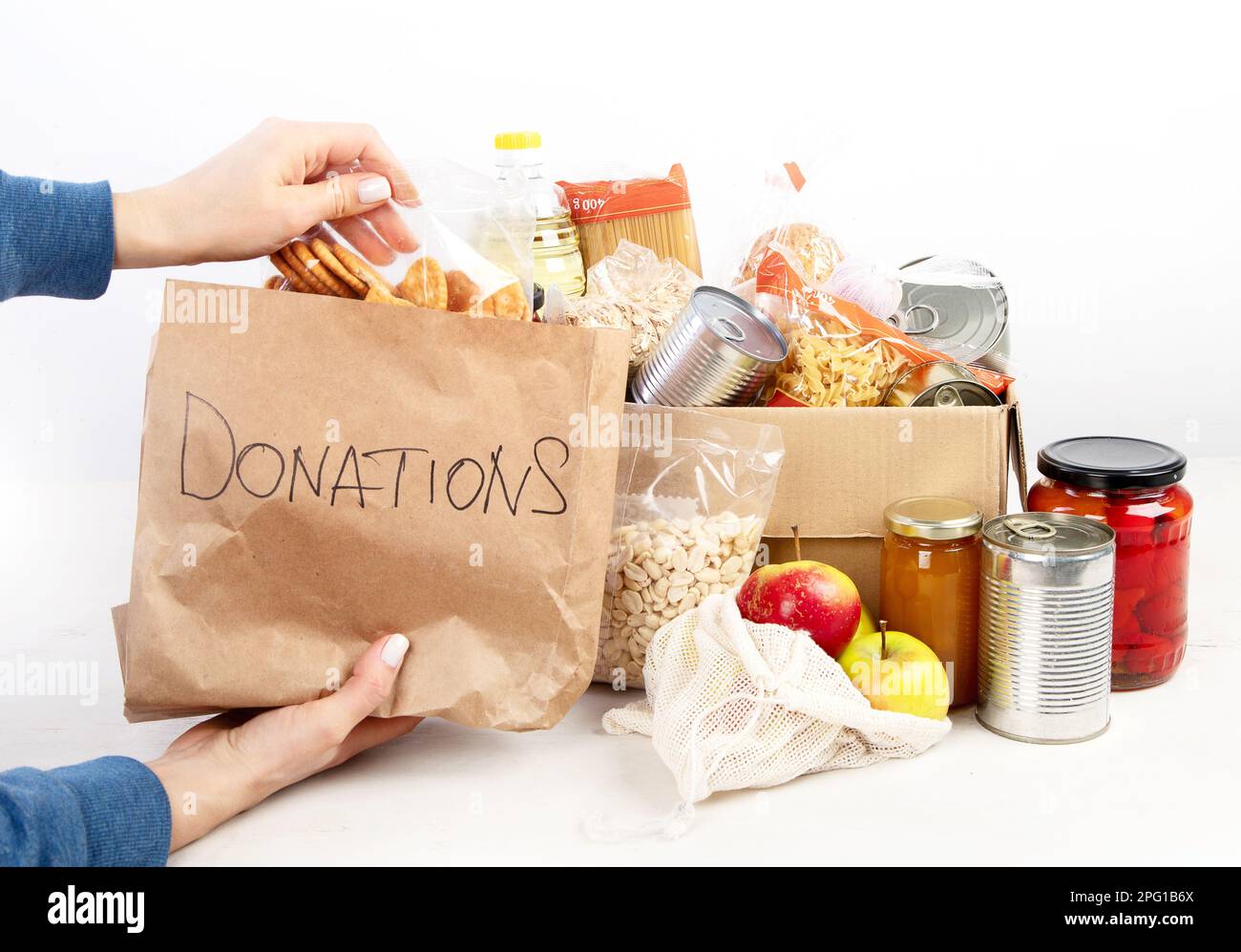 Food donation box of different products on light background, top view