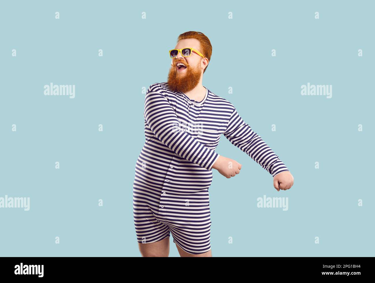 Funny bearded chubby man in sailor leotard having fun on pastel light ...