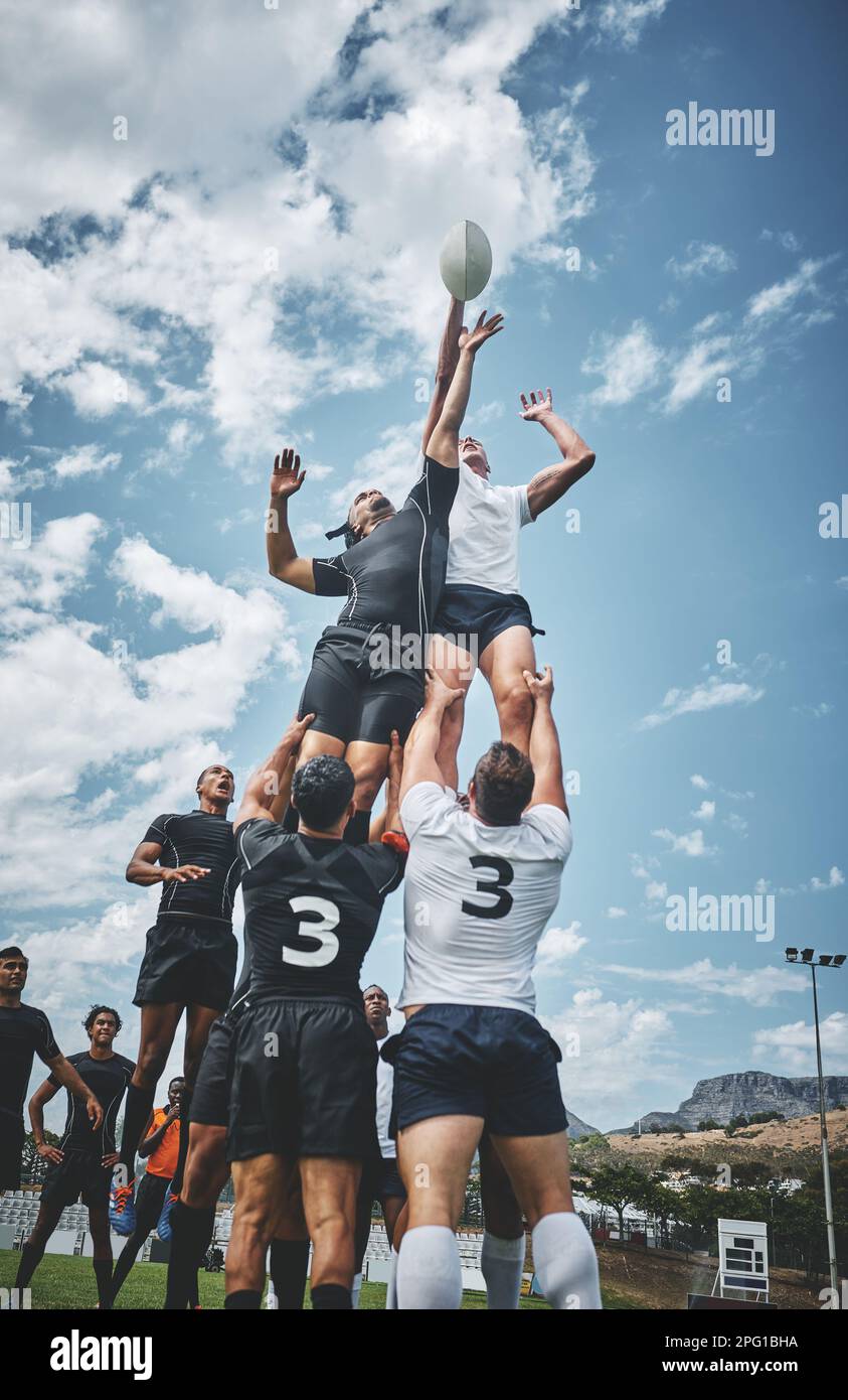 Playing Rugby Outside Its a battle to the top. two rugby teams competing over a ball during a ...
