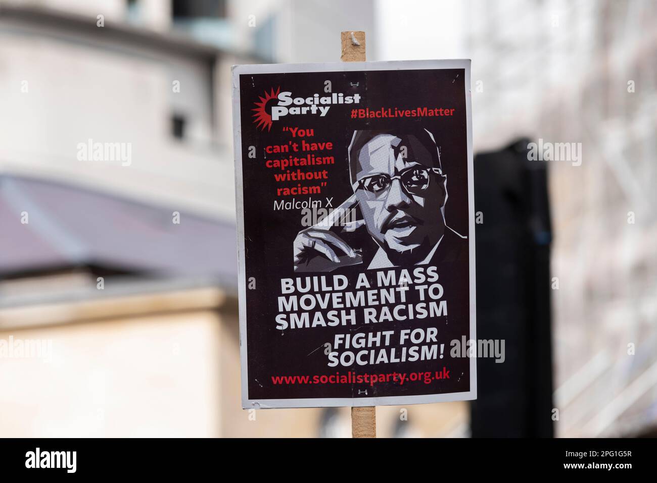 Protest taking place in London, UN Anti Racism Day. Stand up to Racism. Malcolm X quote. Black Lives Matter. You can't have capitalism without racism Stock Photo