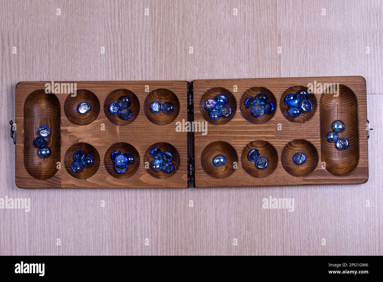 Mangala game board and glass marbles. Historical Turkish game mangala