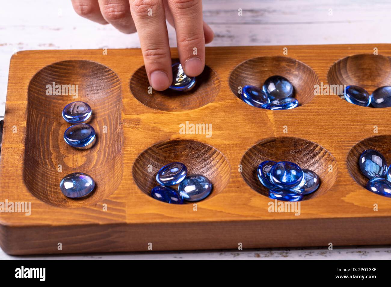 Mangala game board and glass marbles. Historical Turkish game mangala