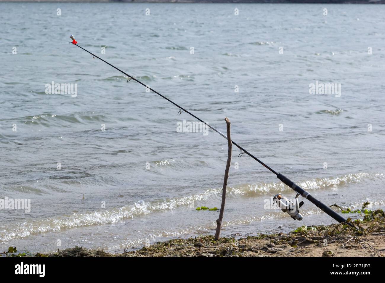 Fishing rods and fishing gear on the river bank, lake coast close up wave  Stock Photo - Alamy