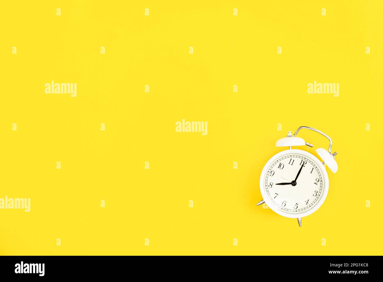 White alarm clock on a yellow background, flat lay Stock Photo - Alamy