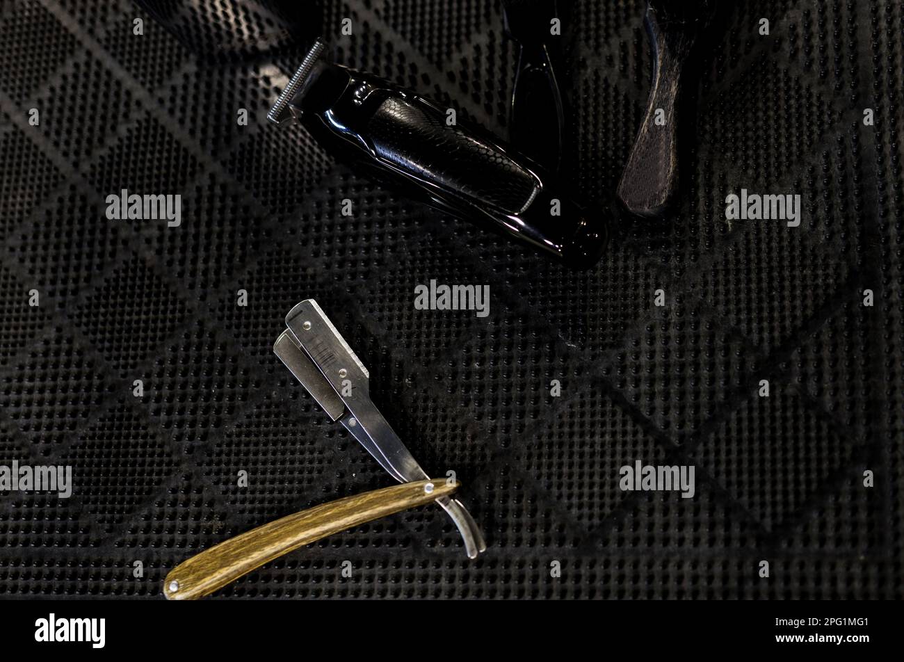 Top view of metal dangerous razor for haircuts with blue on black