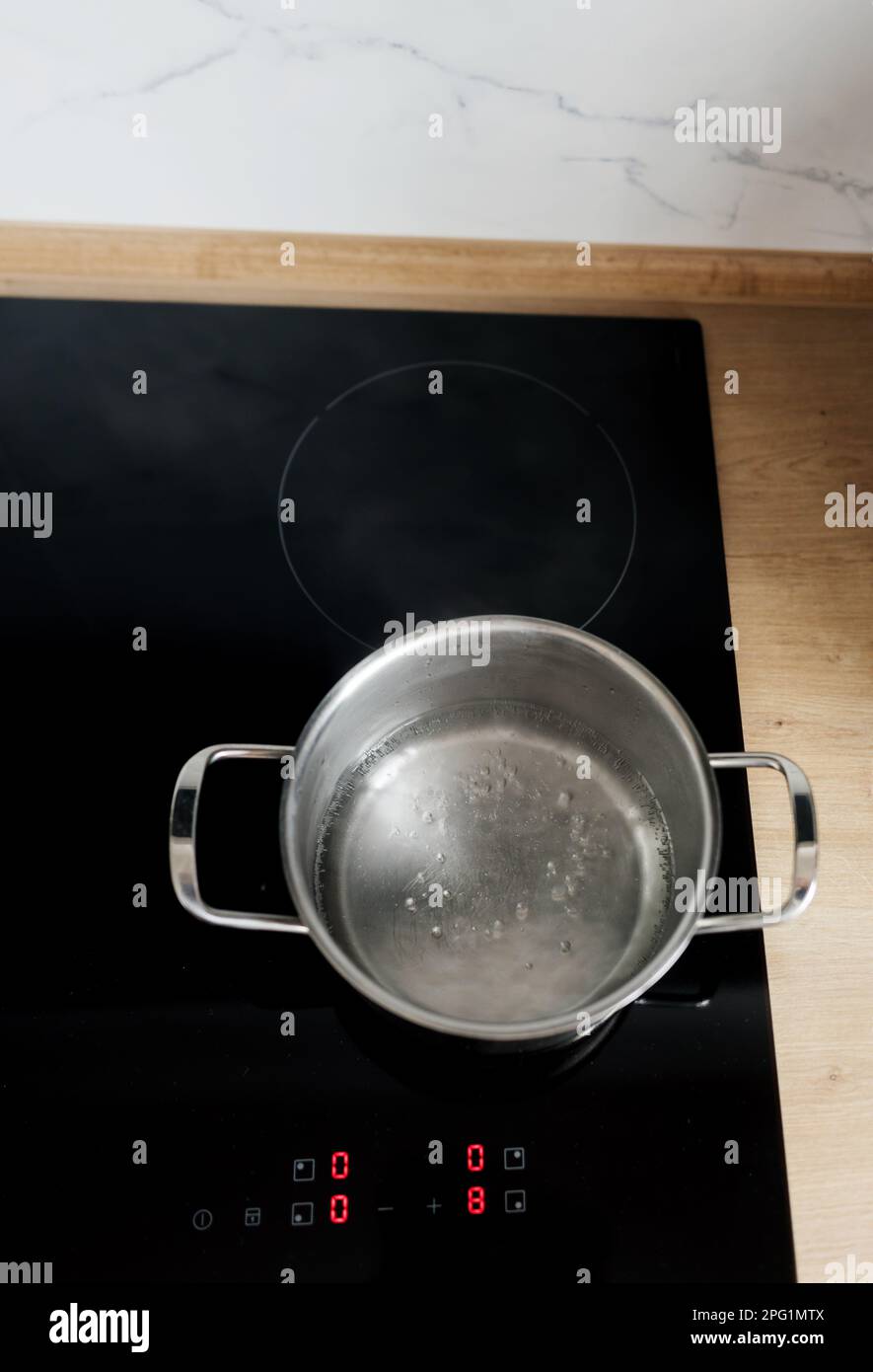 Boiling spaghetti in pan on electric stove in the kitchen. boiling