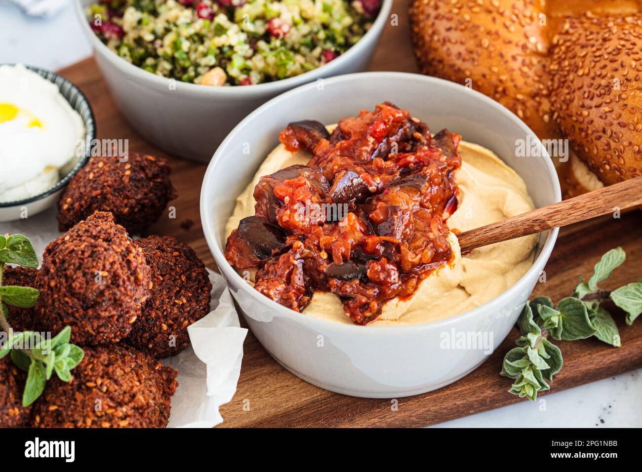 Hummus with eggplant bowl on a party pletter. Israeli food concept