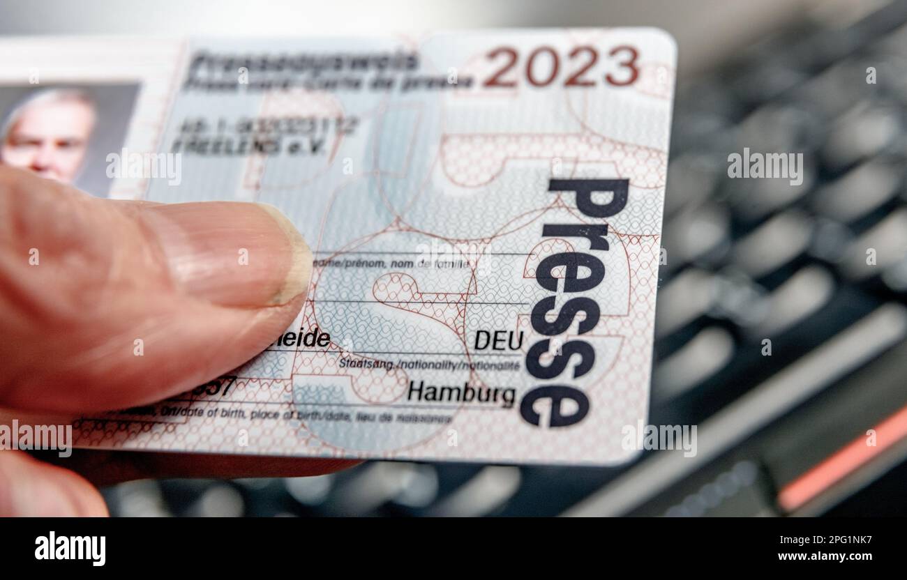 Hamburg, Germany. 19th Mar, 2023. A journalist holds his press card in his hand. The national