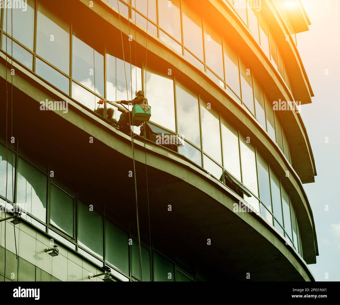 window washer at high altitude washes the facade of a highrise