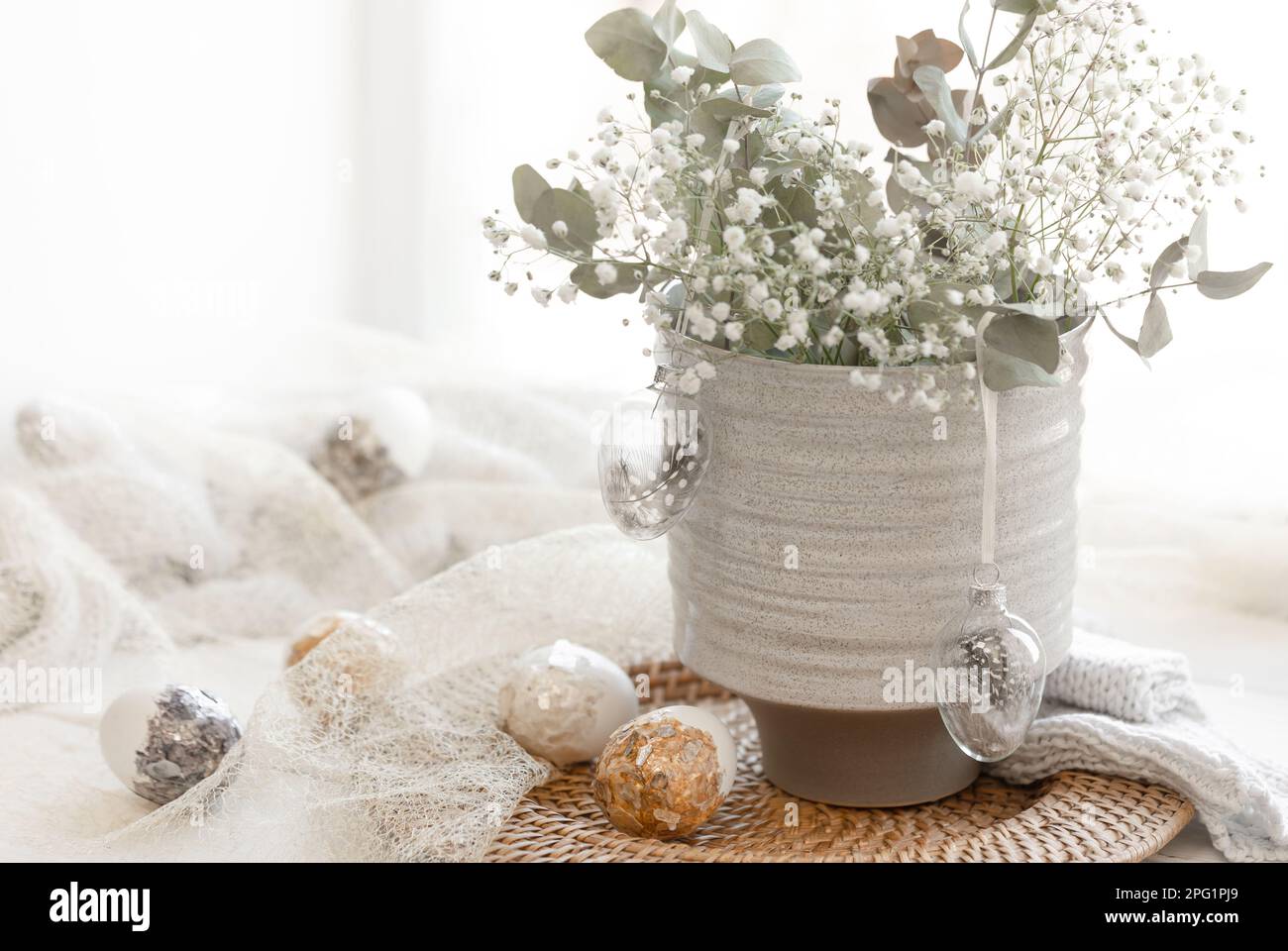 Light Easter composition with Easter eggs and gypsophila flowers. Stock Photo