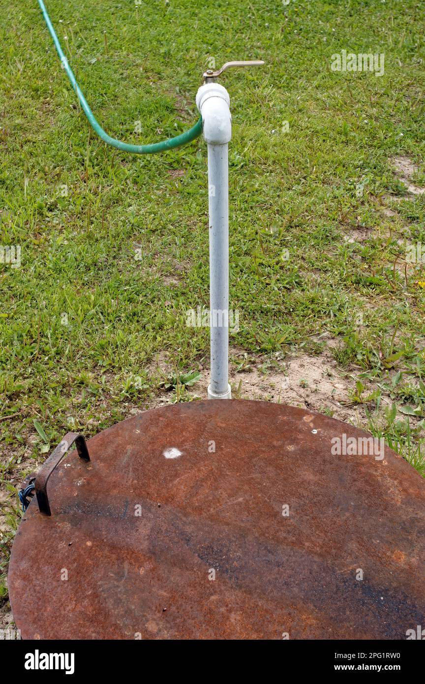plastic pipe from a well with water, watering the garden Stock Photo