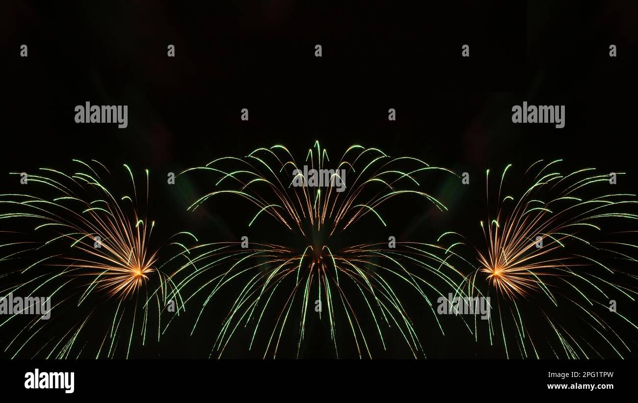 abstract holiday background: green fireworks in night sky Stock Photo ...