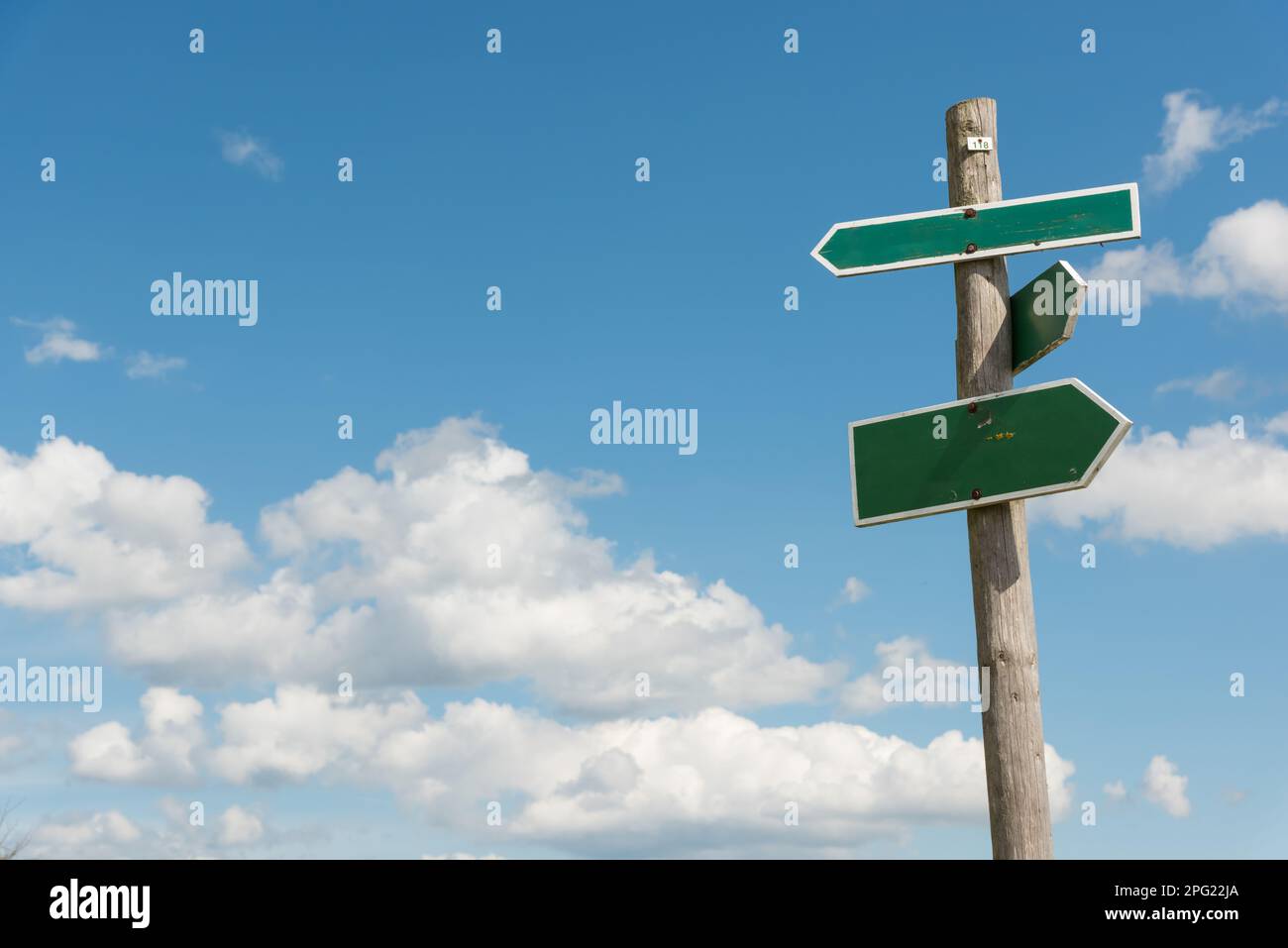 Green signpost with blue sky and white clouds in background Stock Photo ...