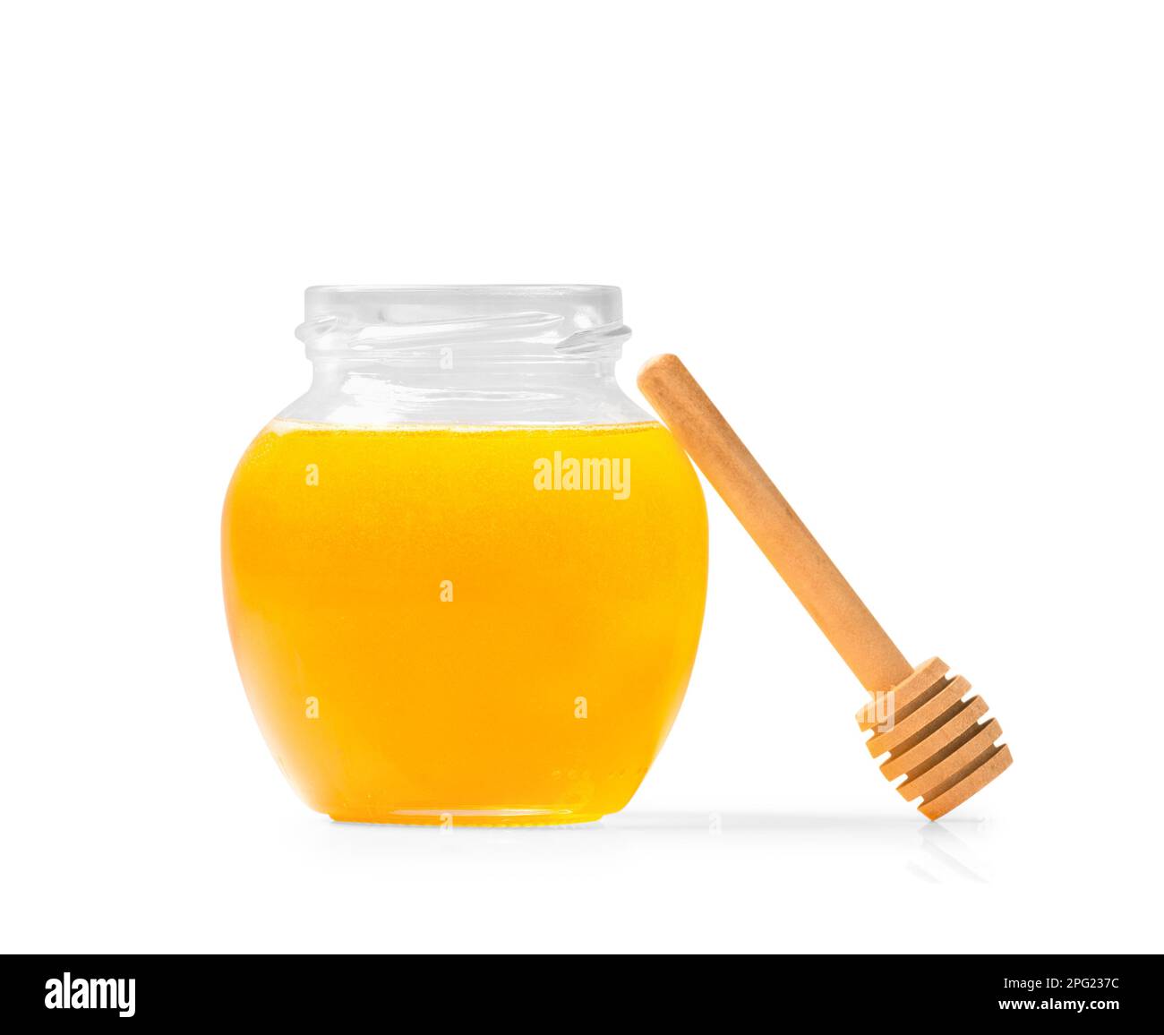 Fresh honey in a jar wooden dipper on a white isolated background Stock
