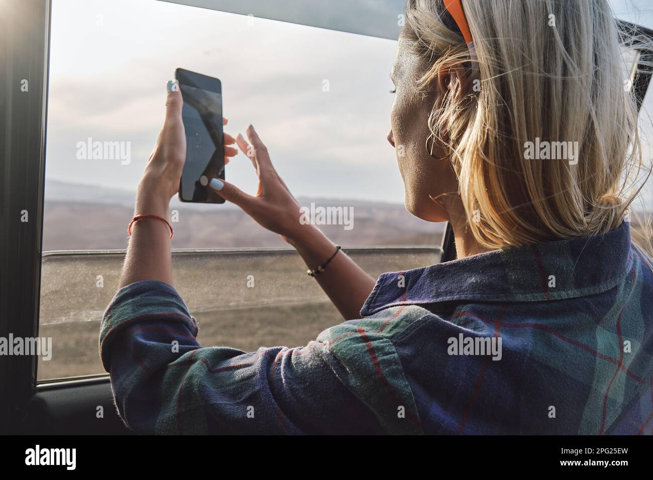 Woman taking a picture of Grand Canyon through the car window Stock ...
