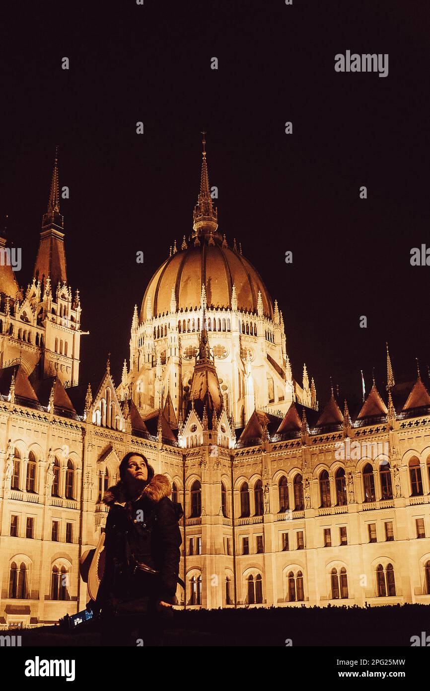 tourist girl looking the city on a side of parliament of Budapest Stock Photo