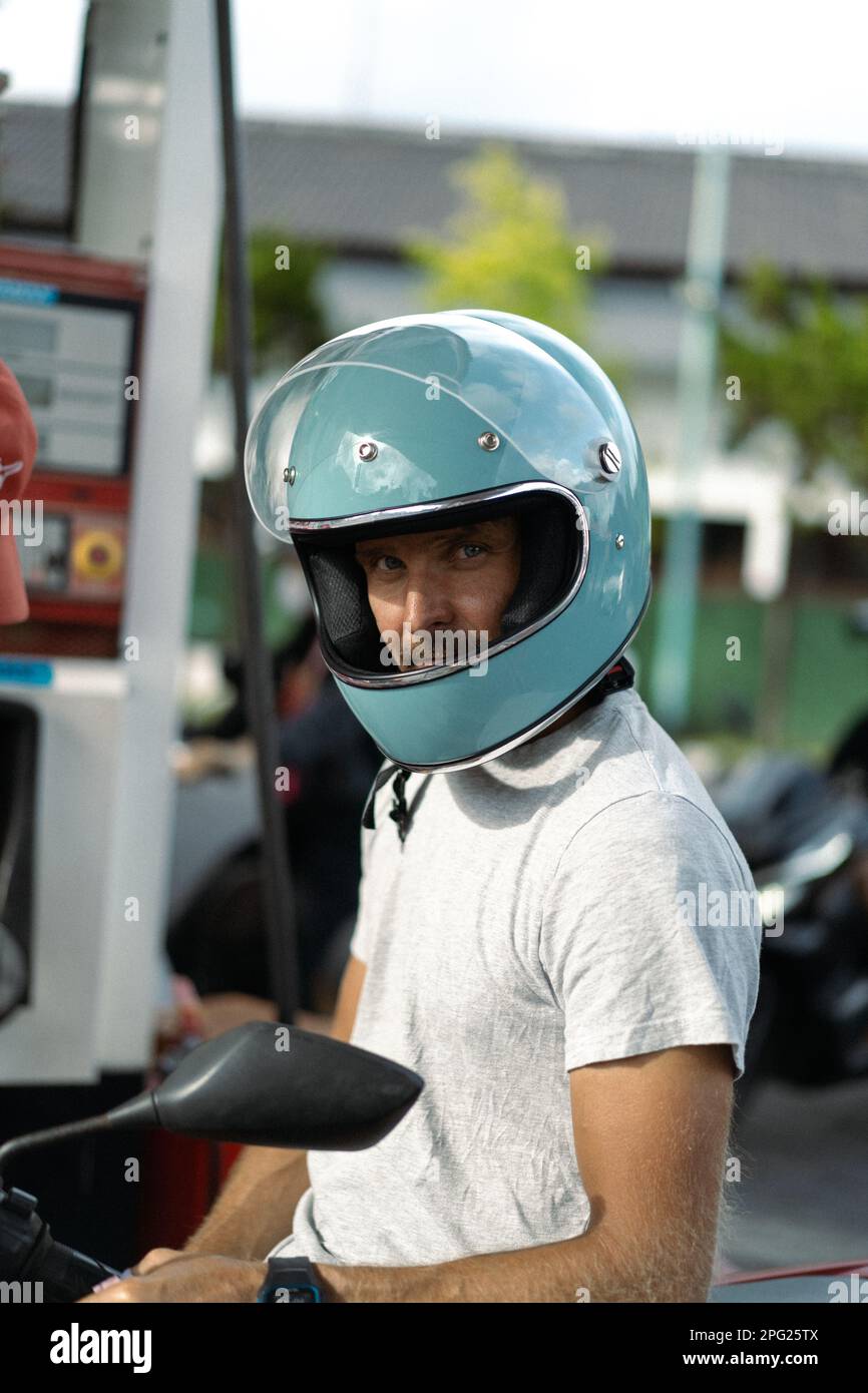 A man in a motorcycle helmet. Bali, Indonesia Stock Photo - Alamy