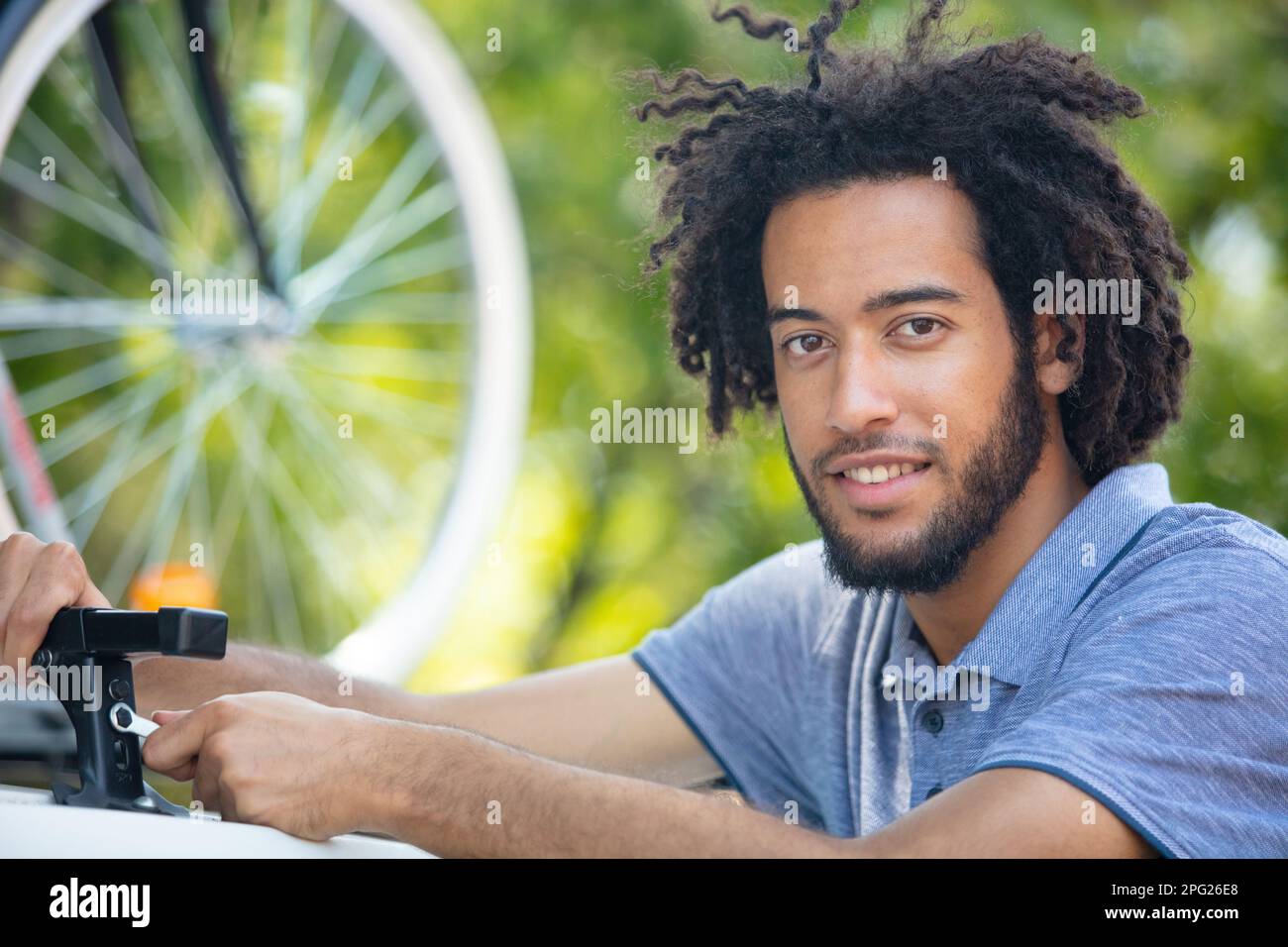 man fixing roof bars on top of his car Stock Photo Alamy