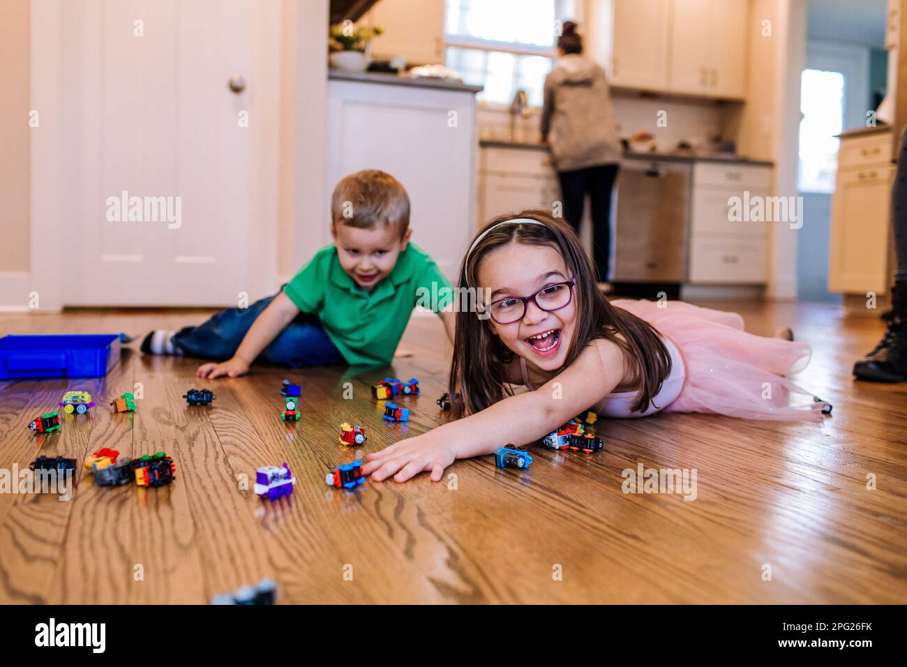 happy siblings playing with train toys Stock Photo - Alamy